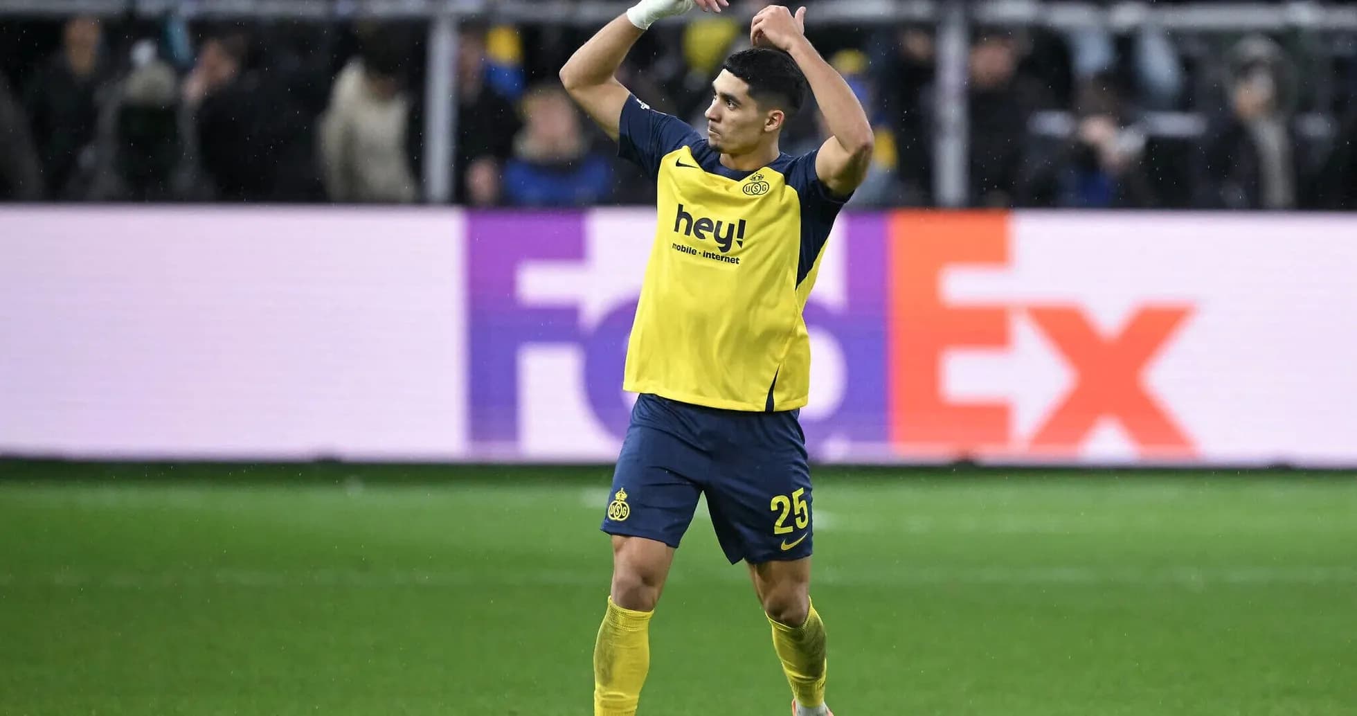 Player celebrating on field wearing yellow jersey Player celebrating on field wearing yellow jersey
