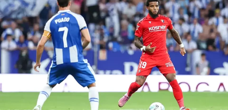 Osasuna player dribbling past Espanyol opponent Osasuna player dribbling past Espanyol opponent