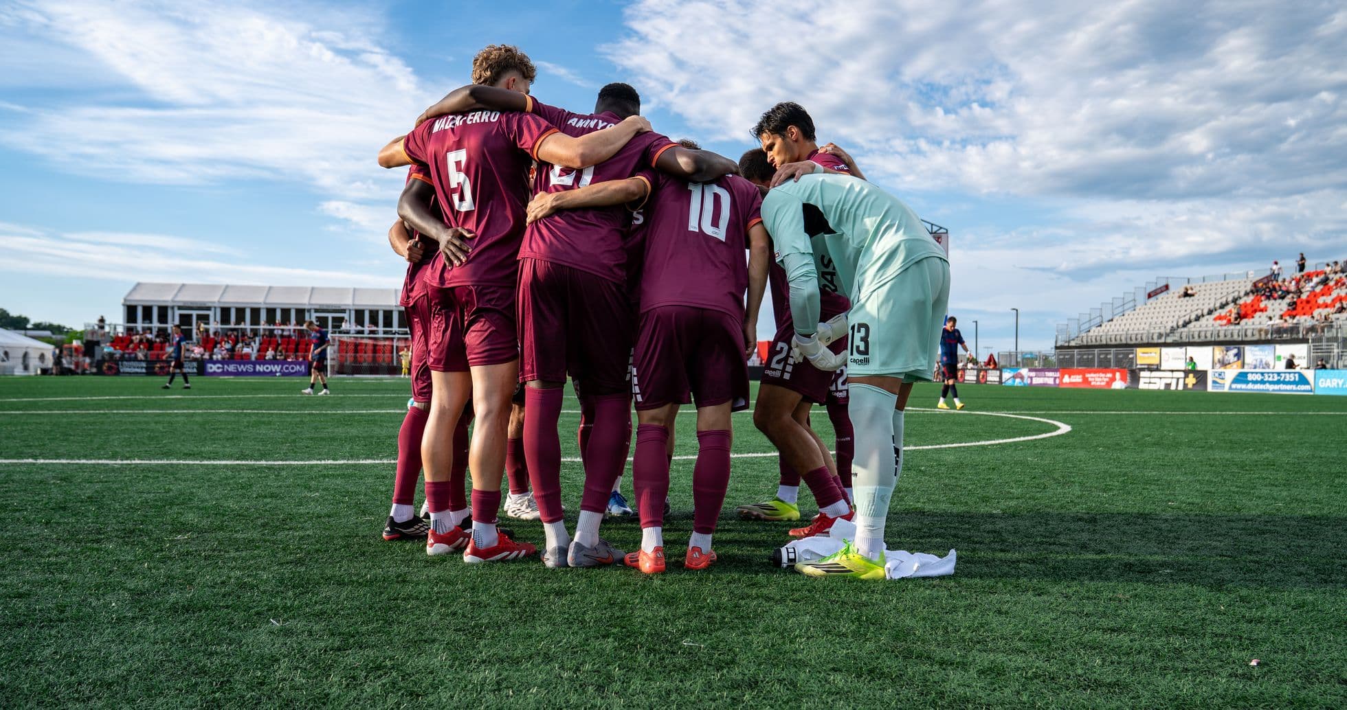 Players huddled before USL League One match Players huddled before USL League One match