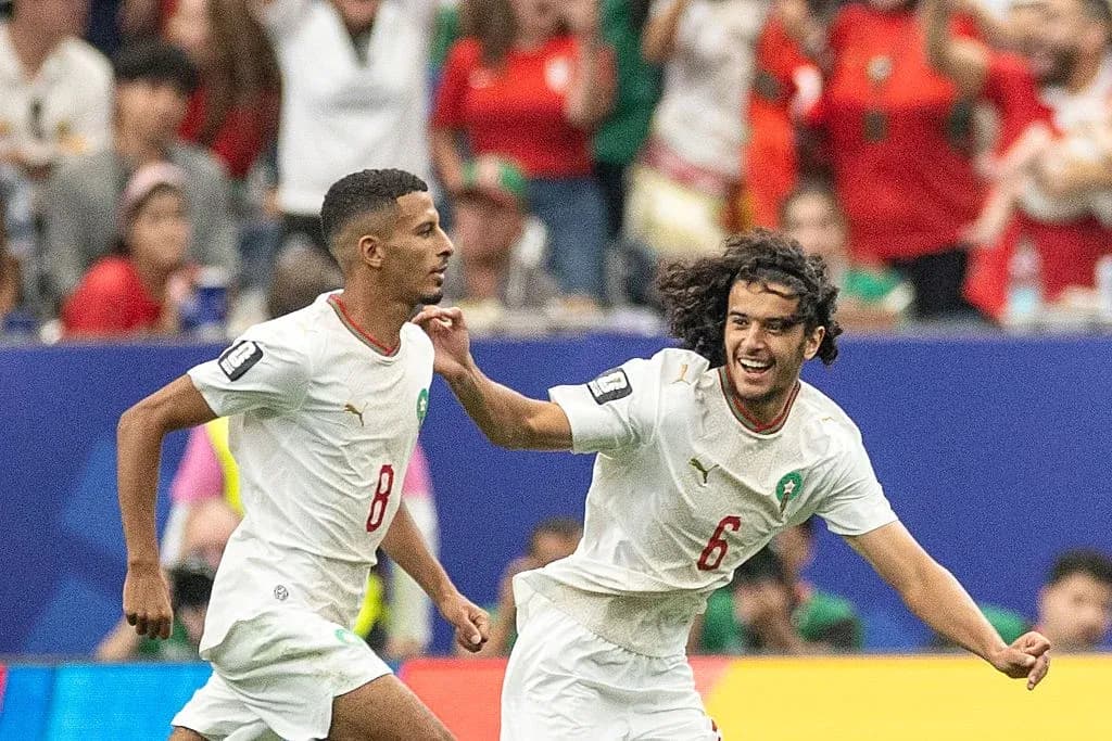 Two Moroccan players celebrating during a match Two Moroccan players celebrating during a match