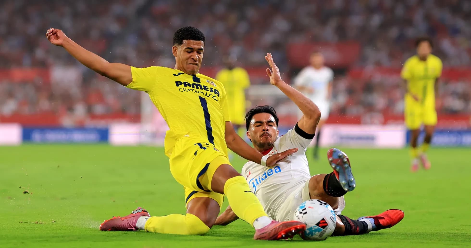 Two players battling for the ball in La Liga Two players battling for the ball in La Liga