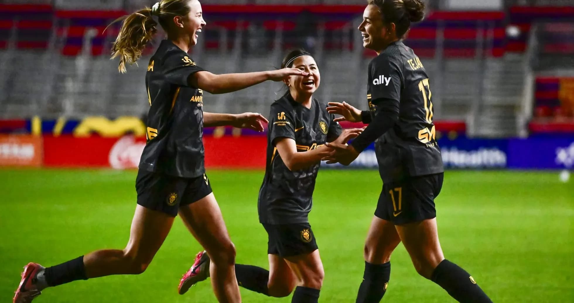 Players celebrating a goal during NWSL match Players celebrating a goal during NWSL match