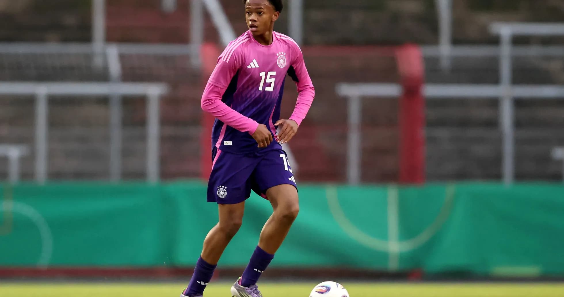 Player in training kit dribbling a soccer ball Player in training kit dribbling a soccer ball