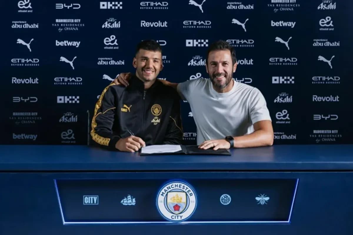 Player signing contract with manager at press conference Player signing contract with manager at press conference