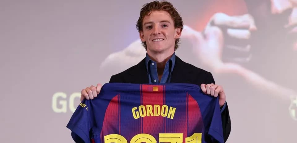 Player holding FC Barcelona jersey at presentation Player holding FC Barcelona jersey at presentation