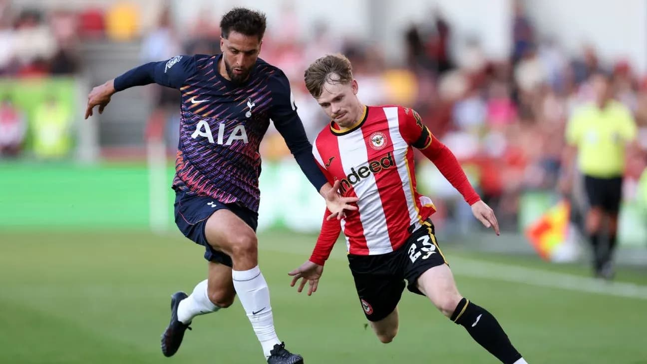 Brentford player competing with Tottenham opponent Brentford player competing with Tottenham opponent