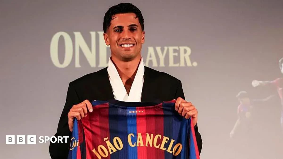 Player holding Barcelona jersey at presentation event Player holding Barcelona jersey at presentation event