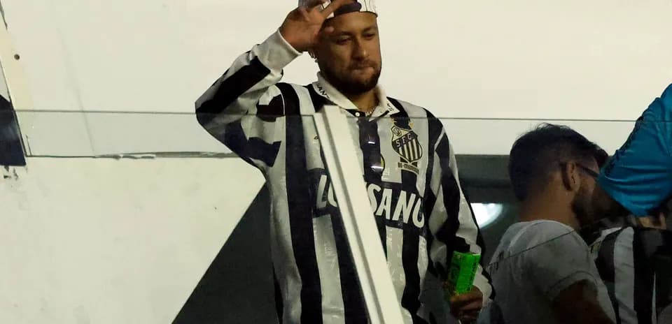 Man waving while wearing Santos FC jersey Man waving while wearing Santos FC jersey