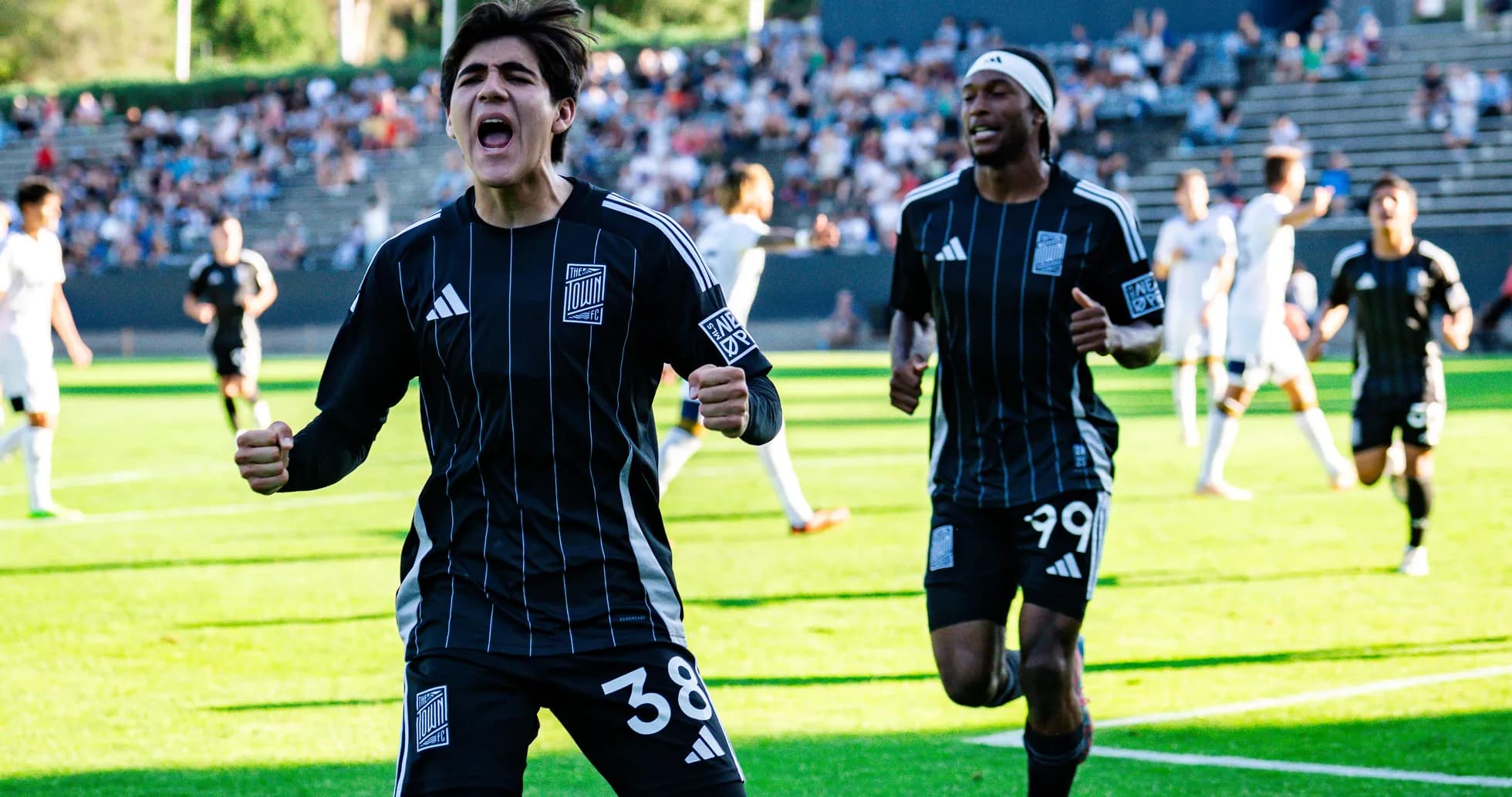 Players celebrating a goal during match Players celebrating a goal during match