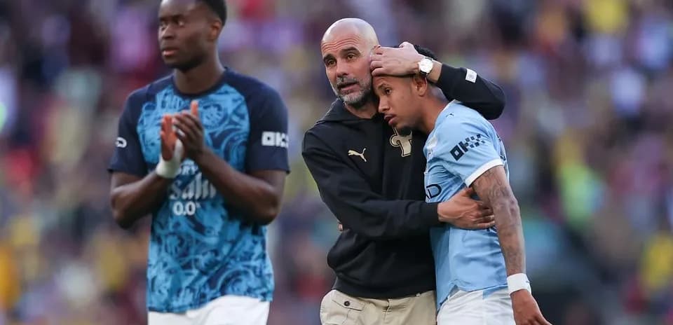 Coach comforting player after match on field Coach comforting player after match on field