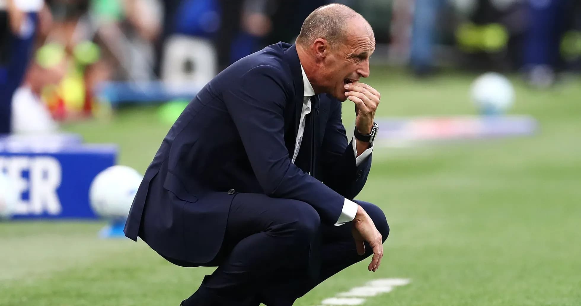 Coach crouching on sidelines during a match Coach crouching on sidelines during a match