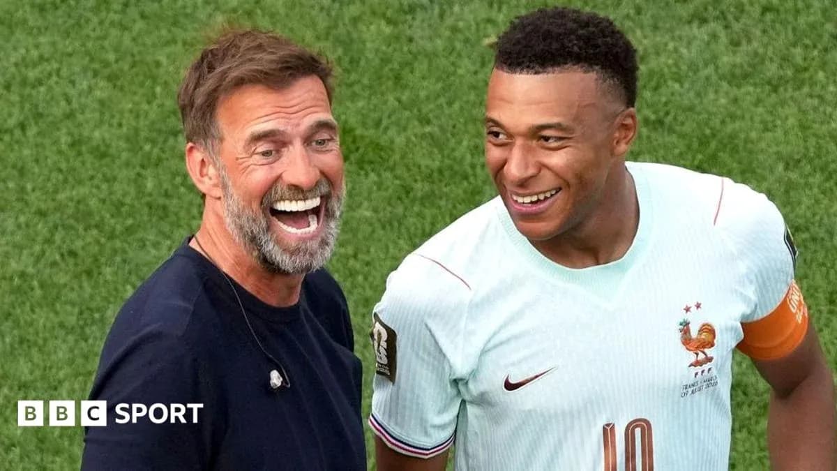Two men smiling on the football pitch Two men smiling on the football pitch