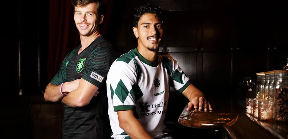Two players posing in team jerseys Two players posing in team jerseys