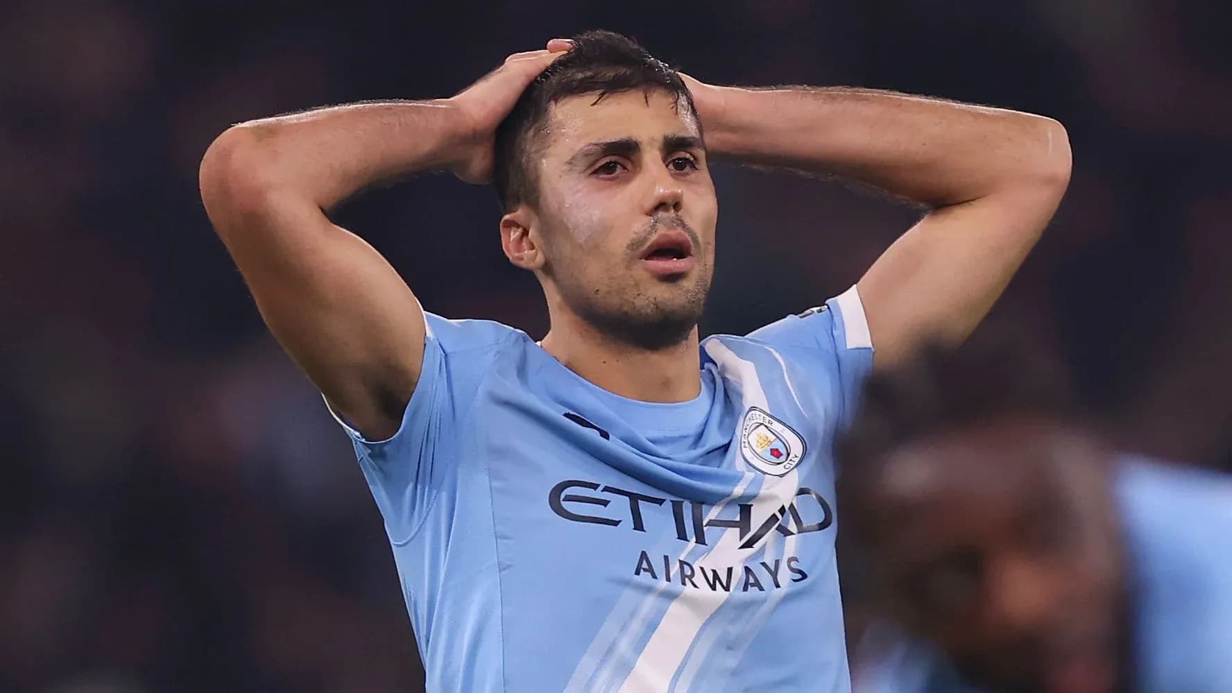 Player in light blue jersey holding head in distress Player in light blue jersey holding head in distress
