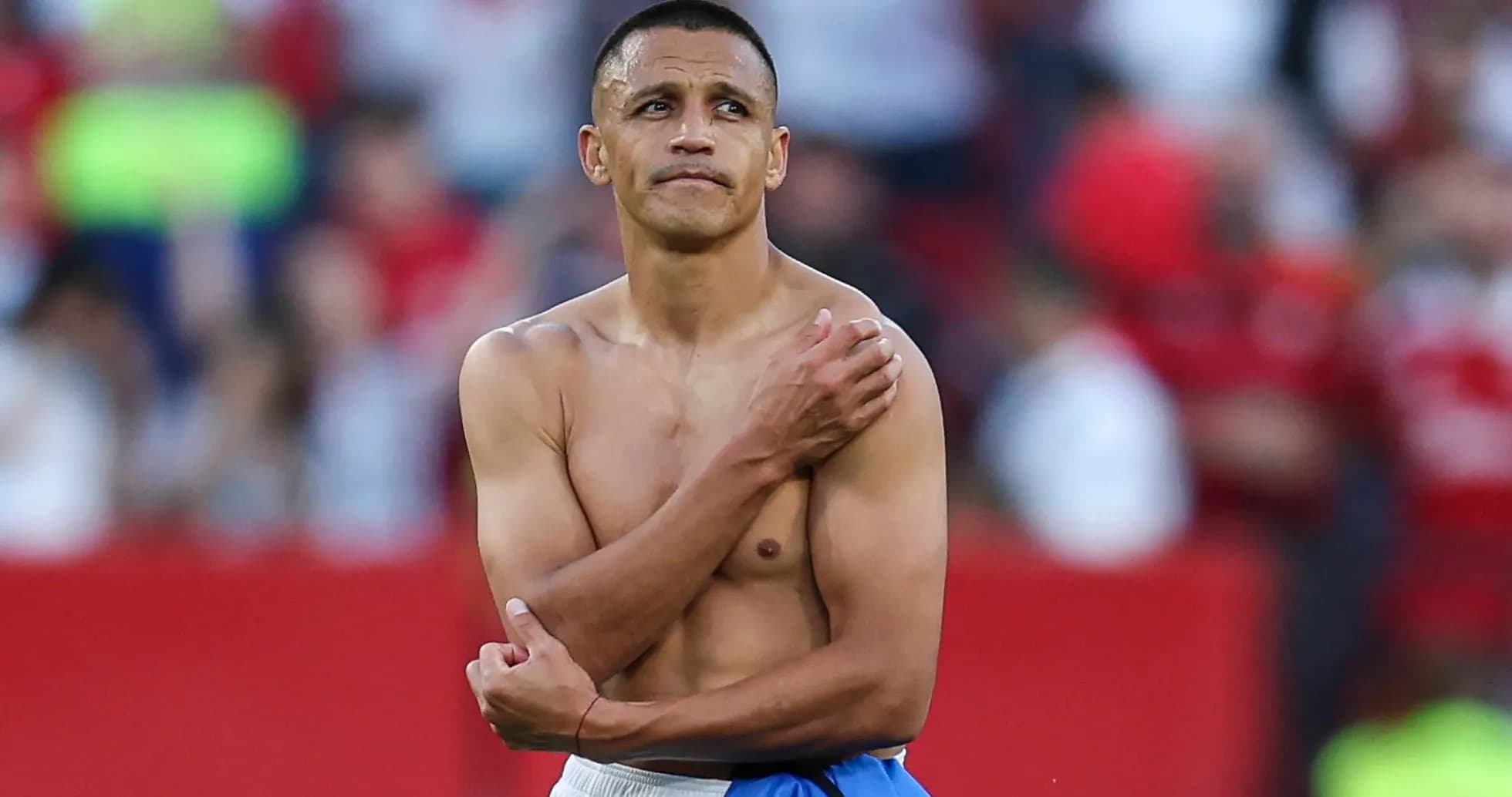 Player with no shirt standing on the pitch Player with no shirt standing on the pitch