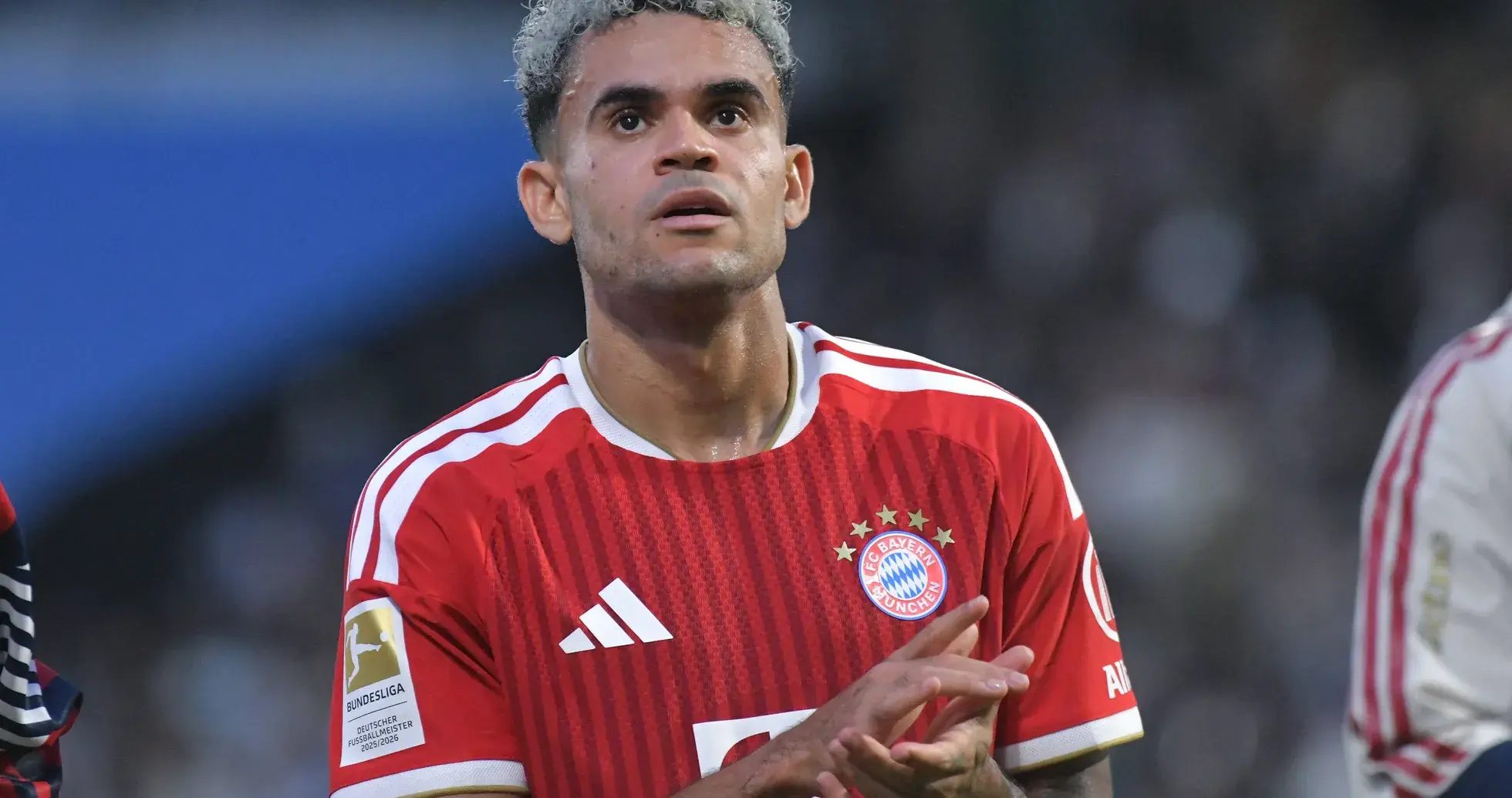 Player in Bayern Munich jersey clapping on field Player in Bayern Munich jersey clapping on field