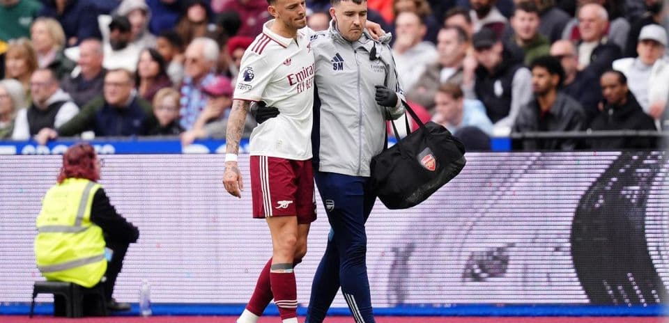 Player being assisted off the field by medical staff Player being assisted off the field by medical staff