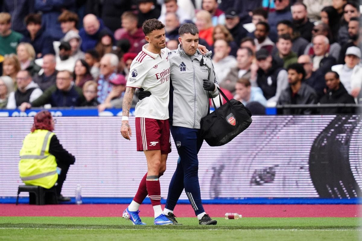 Player being assisted off the field by medical staff Player being assisted off the field by medical staff