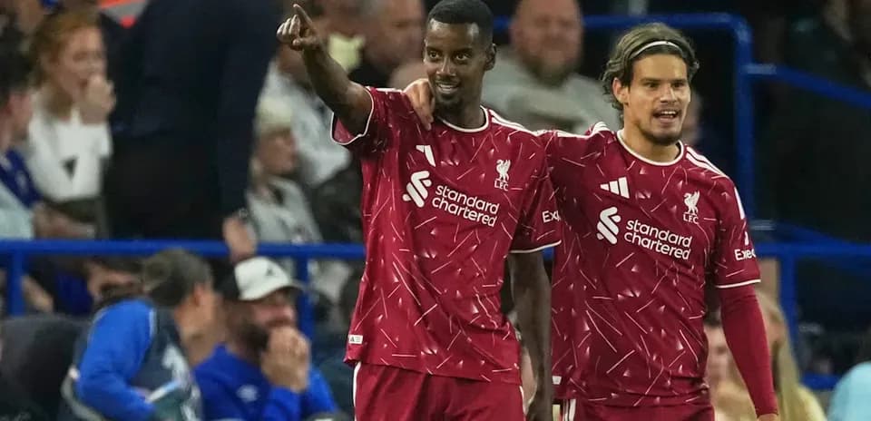 Liverpool players celebrating a goal on the pitch Liverpool players celebrating a goal on the pitch
