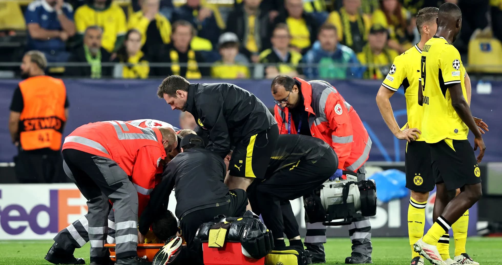 Medical team attending to injured player on field Medical team attending to injured player on field