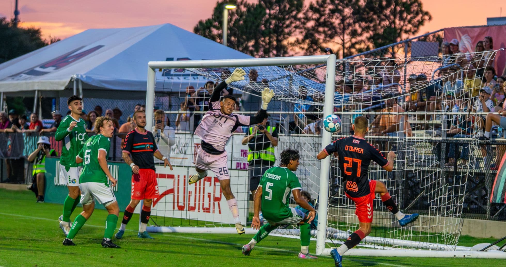 Goalkeeper attempting to save a shot on goal Goalkeeper attempting to save a shot on goal