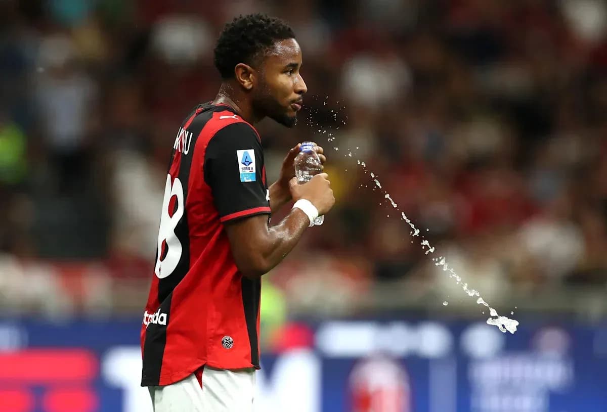 Player spraying water while holding a bottle Player spraying water while holding a bottle
