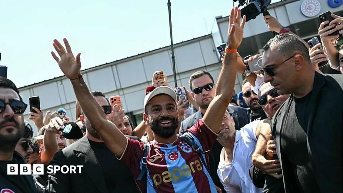Player waving to fans during arrival event Player waving to fans during arrival event