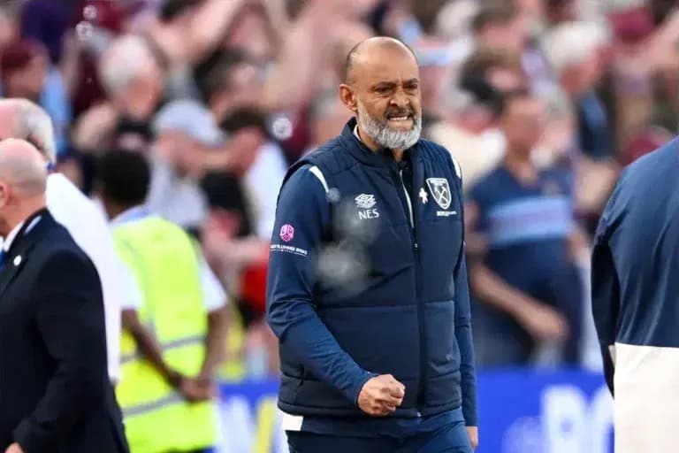 Manager celebrating during match with fans in background Manager celebrating during match with fans in background