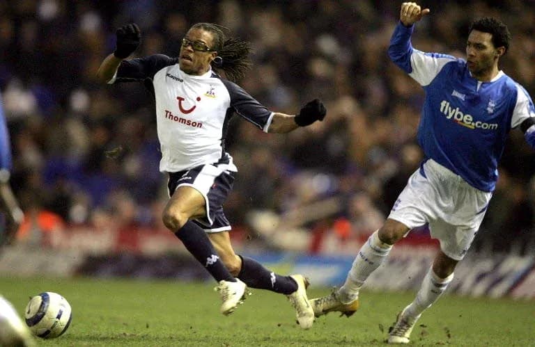 Player evading opponent during football match action Player evading opponent during football match action