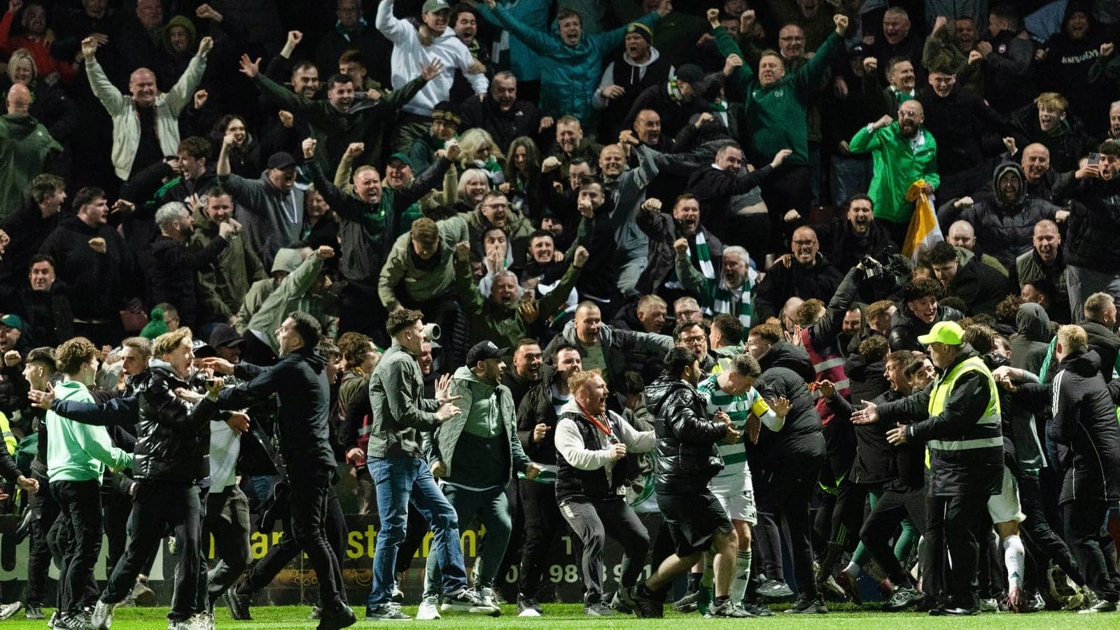 Fans celebrating during a football match on field Fans celebrating during a football match on field