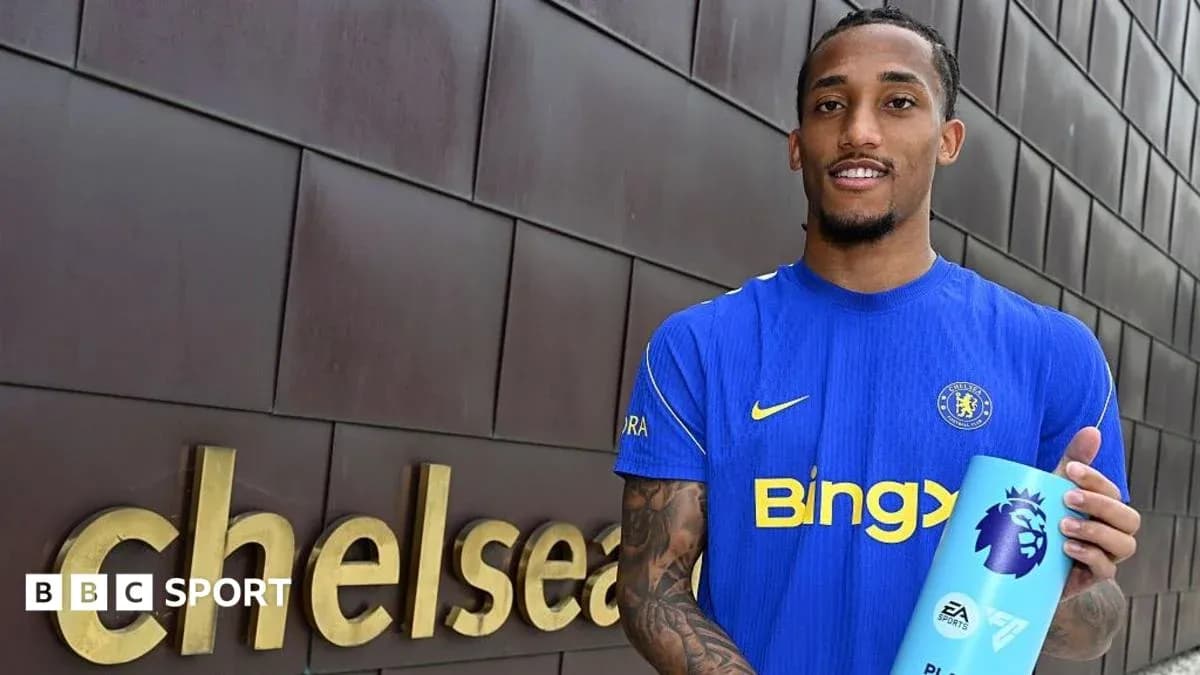 Player holding Premier League trophy at Chelsea venue Player holding Premier League trophy at Chelsea venue