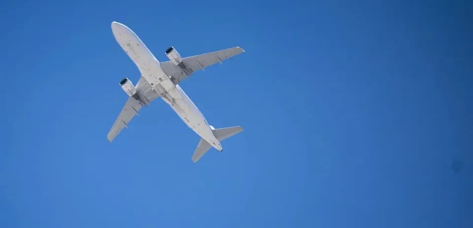 Airplane flying against clear blue sky Airplane flying against clear blue sky