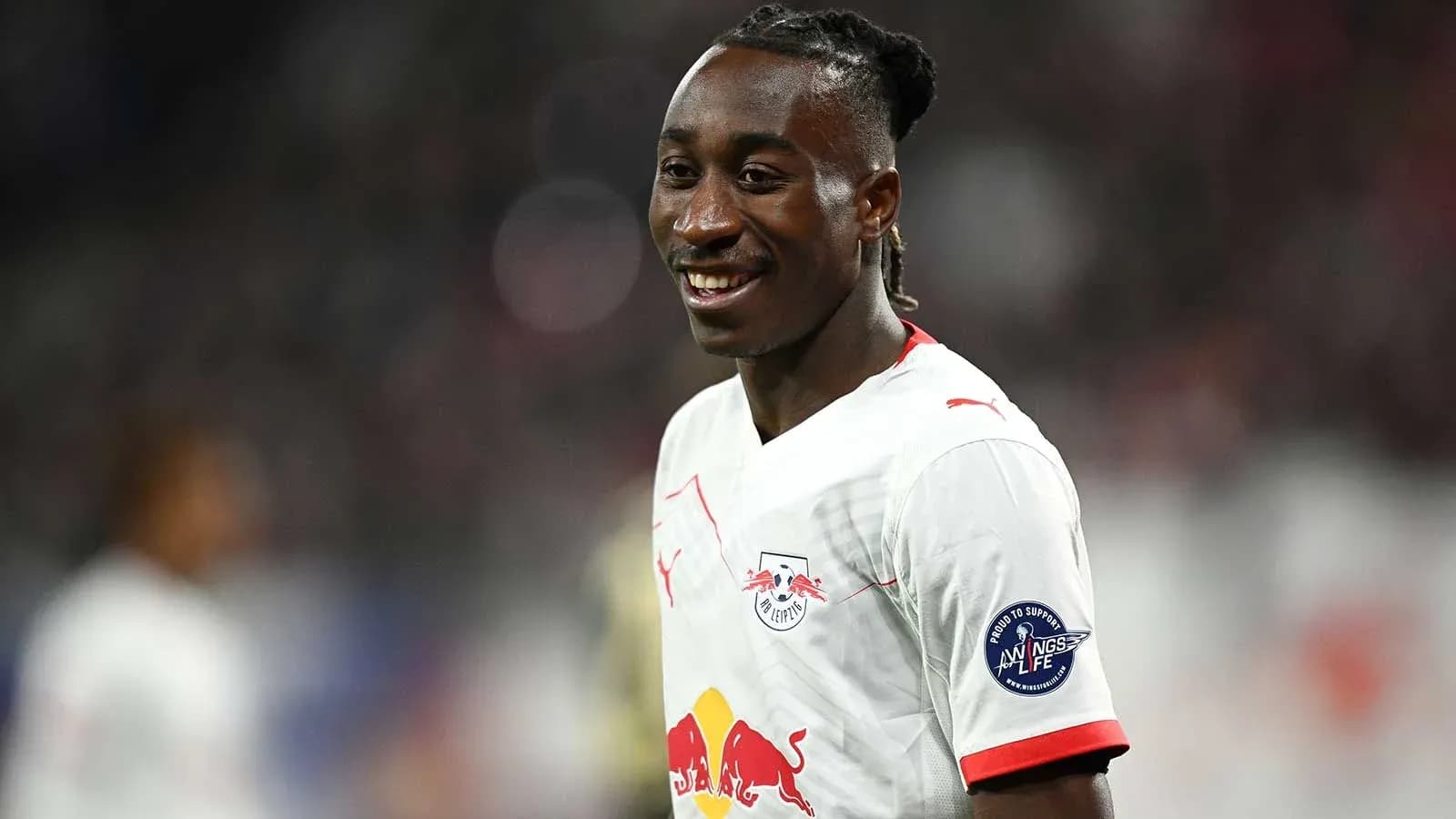Player smiling while wearing RB Leipzig jersey Player smiling while wearing RB Leipzig jersey