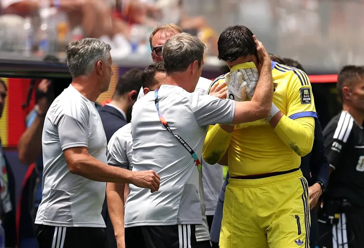 Goalkeeper receiving support from coaching staff on sidelines Goalkeeper receiving support from coaching staff on sidelines