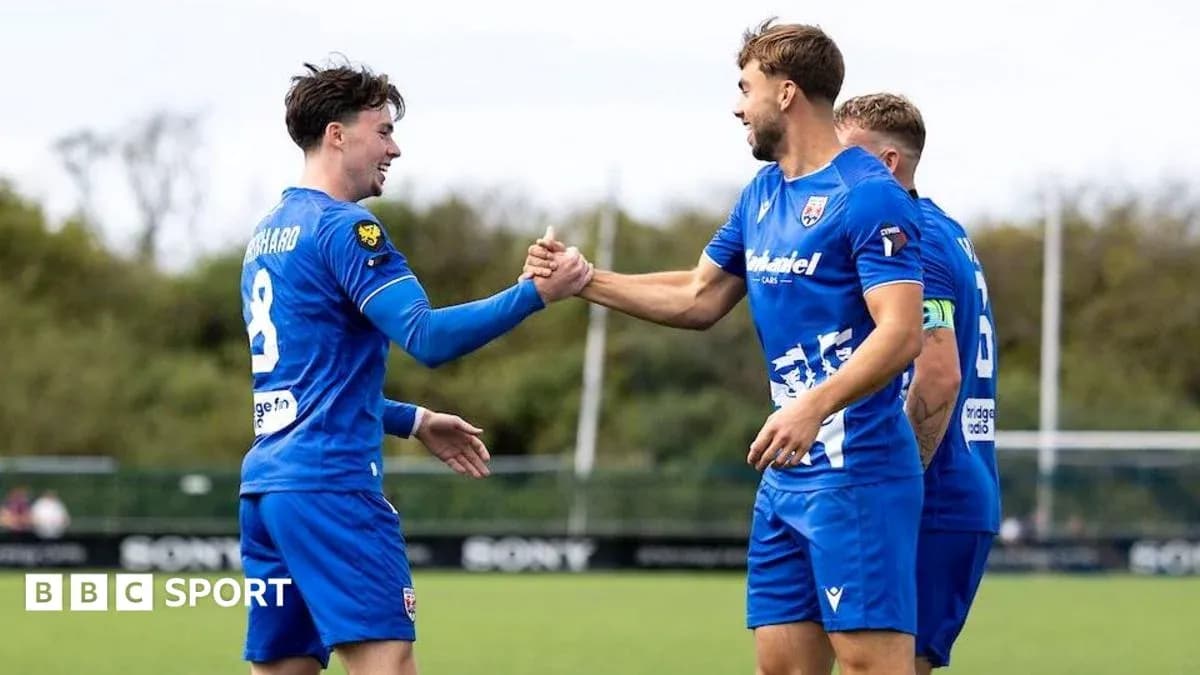 Two players celebrating a goal with handshake Two players celebrating a goal with handshake