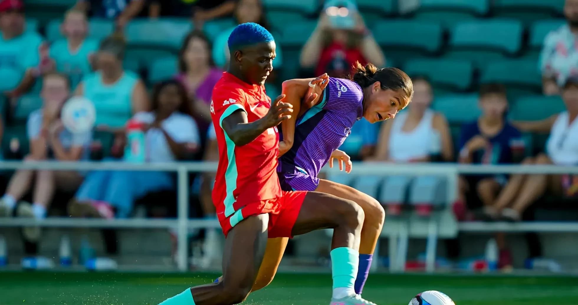 Players competing for the ball in NWSL match Players competing for the ball in NWSL match