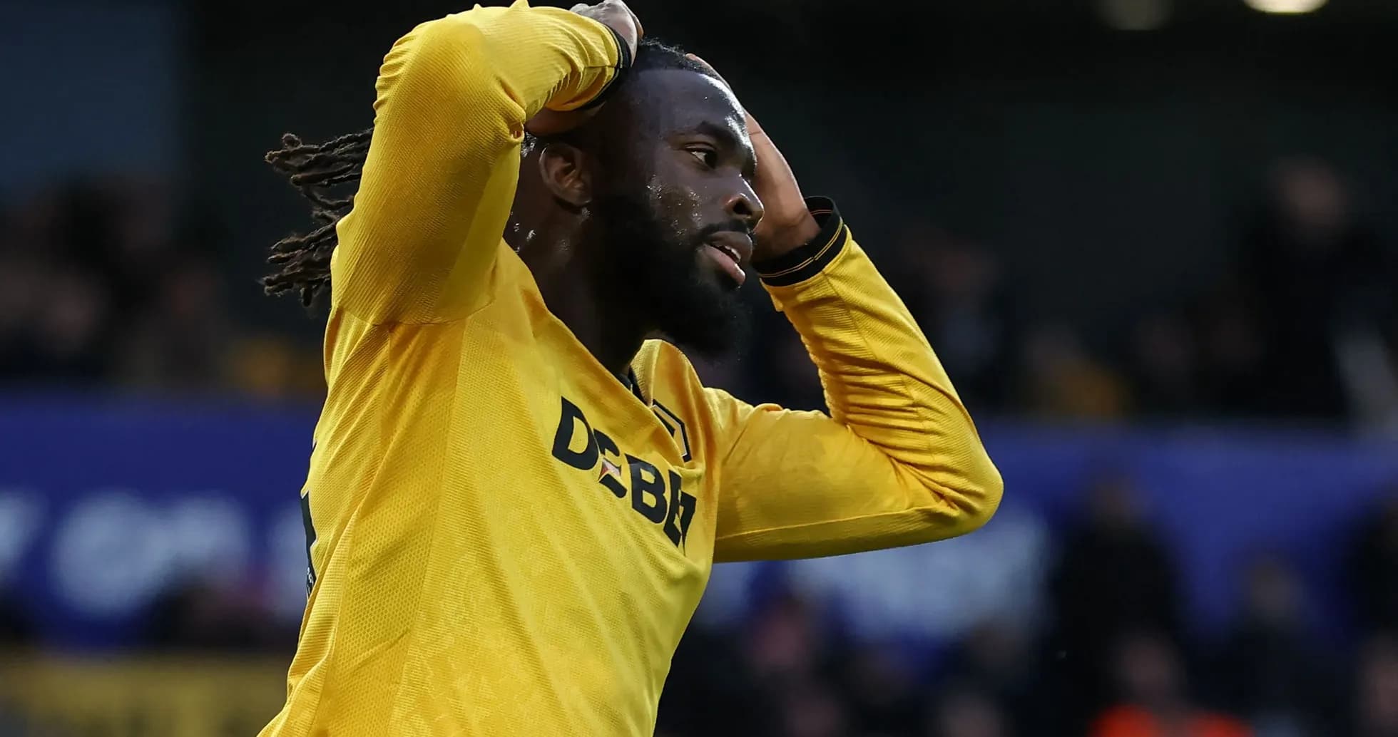 Player in yellow jersey holding head in frustration Player in yellow jersey holding head in frustration