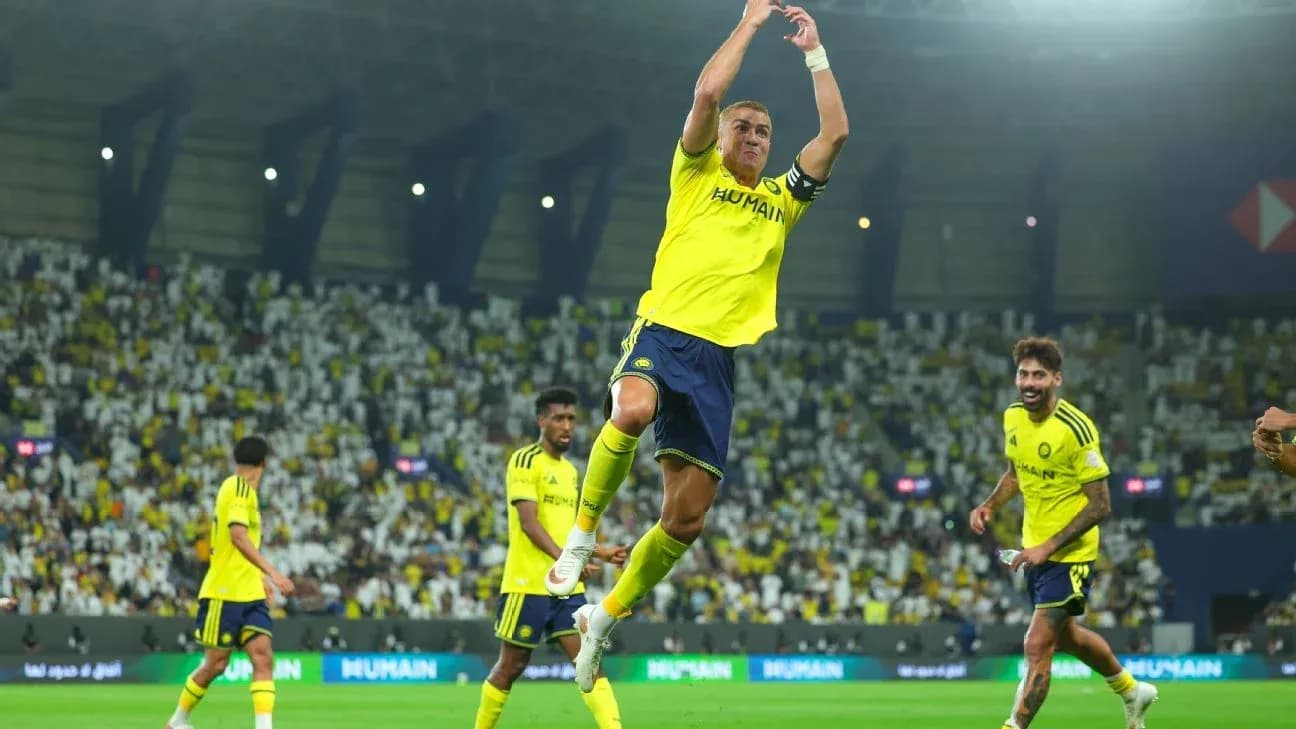 Player celebrating a goal with teammates on field Player celebrating a goal with teammates on field