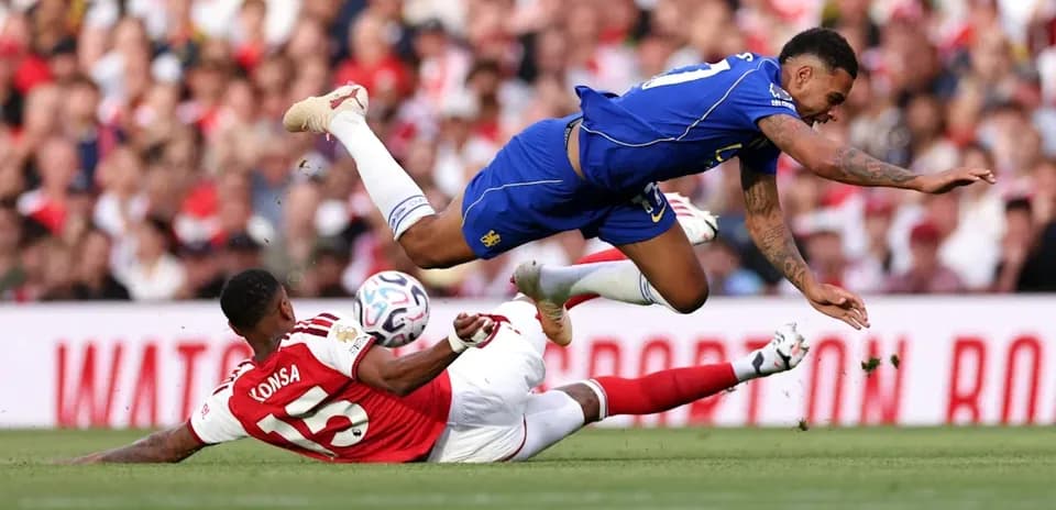 Player falling after a tackle during a match Player falling after a tackle during a match