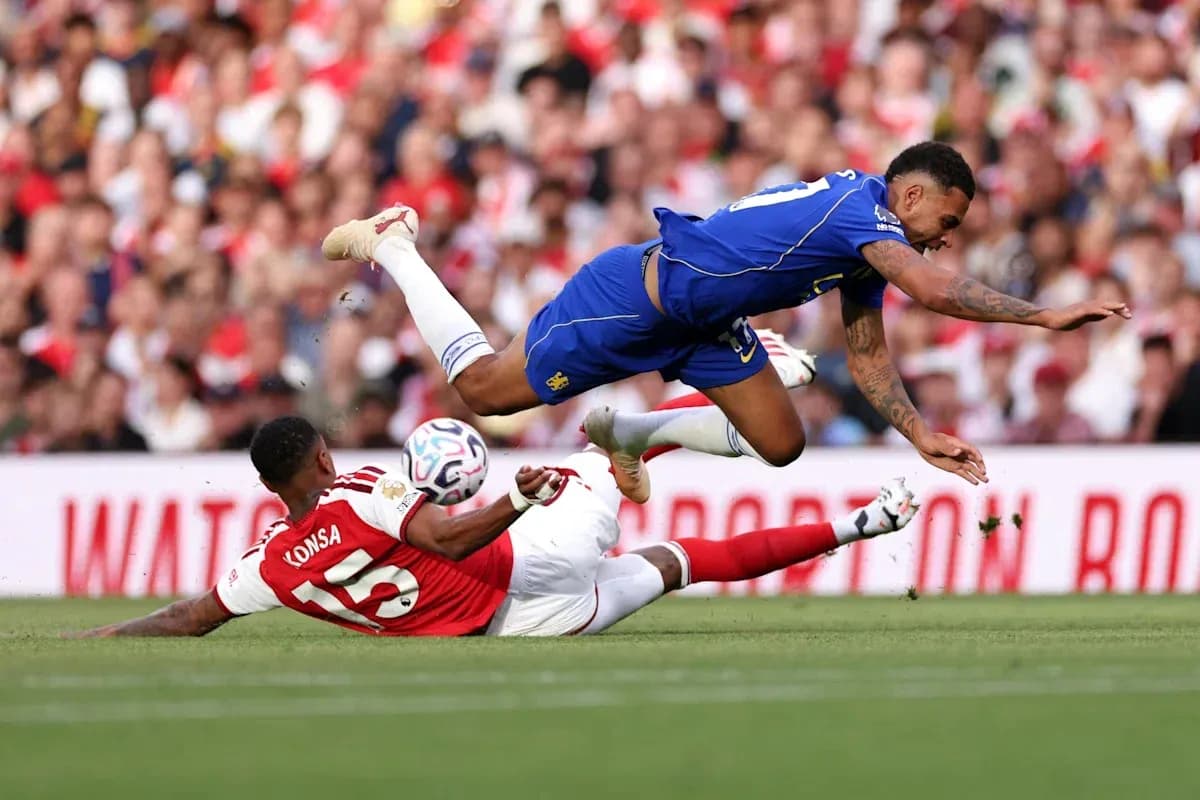 Player falling after a tackle during a match Player falling after a tackle during a match