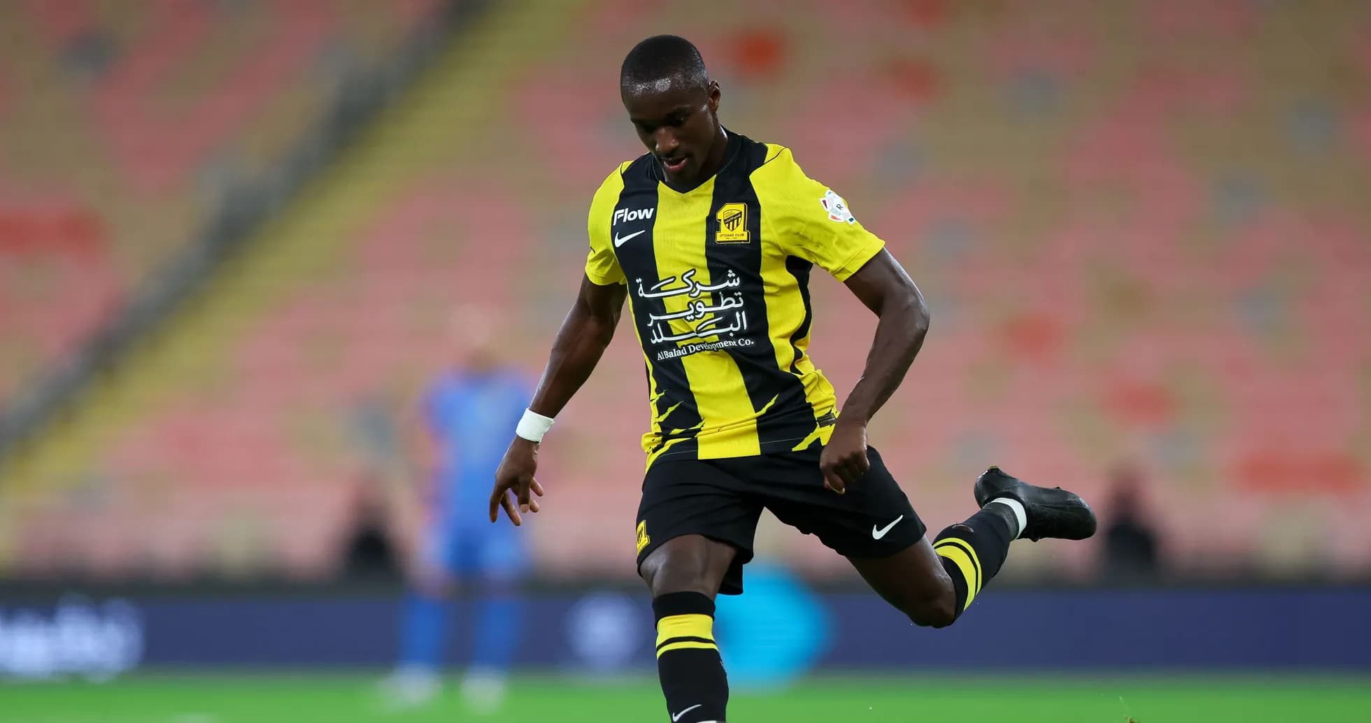Player kicking the ball during a football match Player kicking the ball during a football match