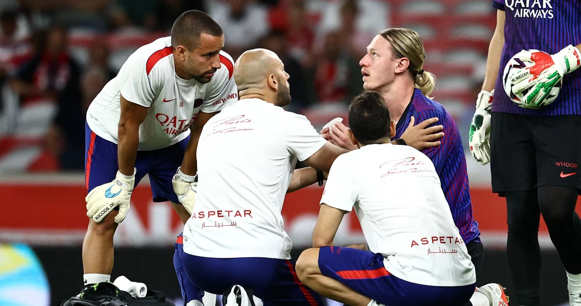 Medical team attending to injured player on field Medical team attending to injured player on field