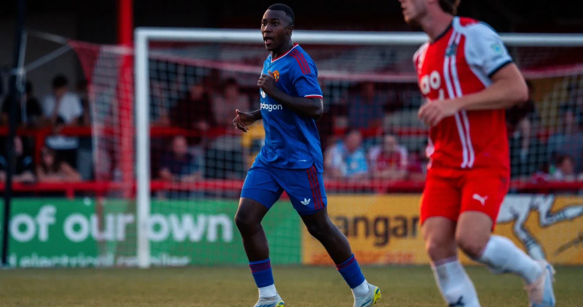 Player in blue kit running on the field Player in blue kit running on the field