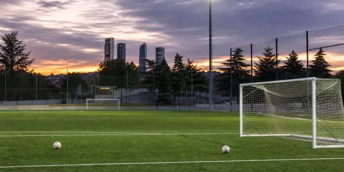 Football field with goalposts and sunset skyline Football field with goalposts and sunset skyline