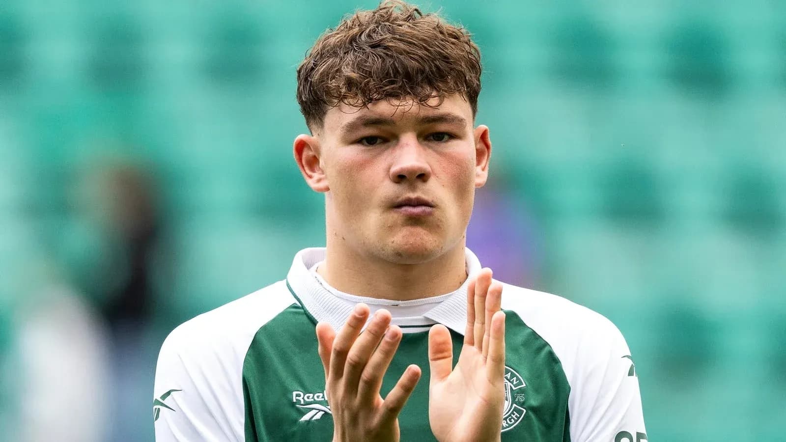Player applauding in Hibernian FC kit Player applauding in Hibernian FC kit