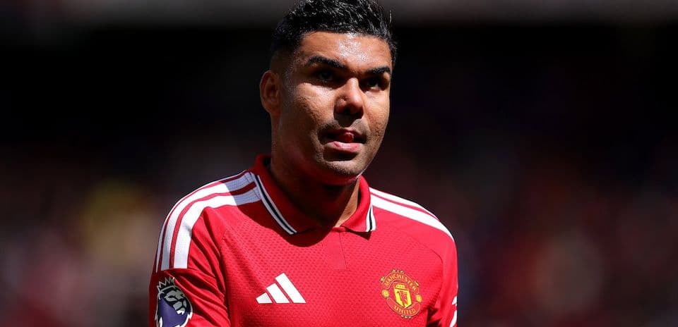 Player wearing Manchester United kit on field Player wearing Manchester United kit on field