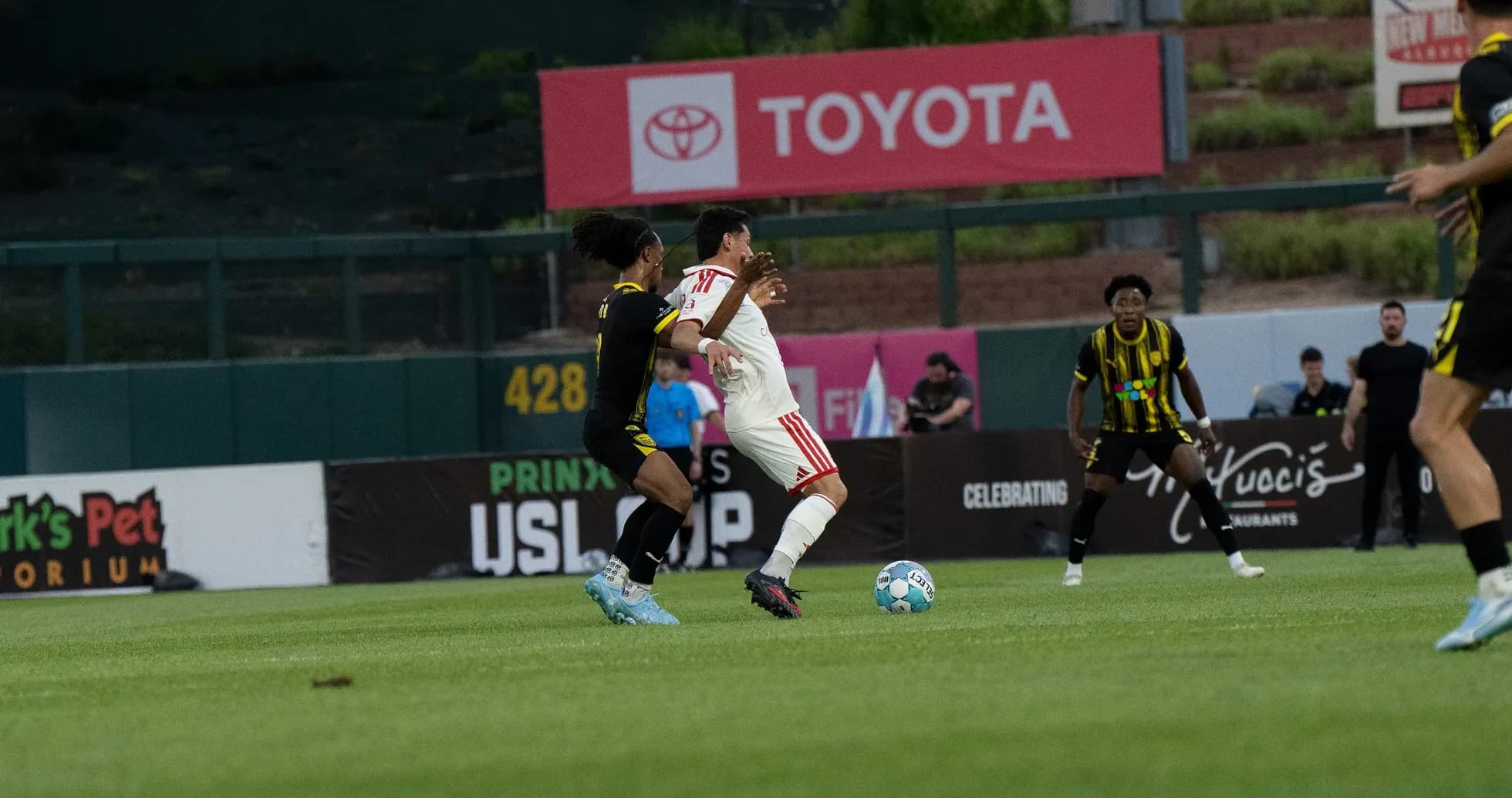 Players competing for the ball in USL match Players competing for the ball in USL match