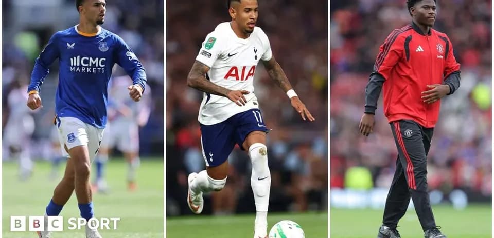 Three football players in team kits on the field Three football players in team kits on the field