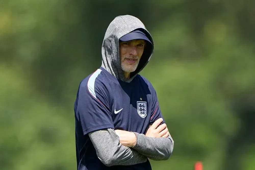 Coach observing training session in hooded sweatshirt Coach observing training session in hooded sweatshirt
