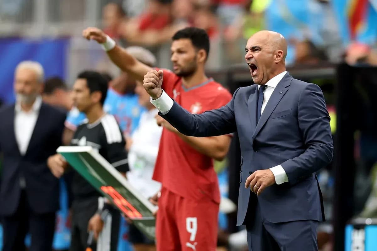 Coach passionately instructing players from the sidelines Coach passionately instructing players from the sidelines